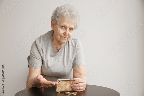 Senior woman counting coins...