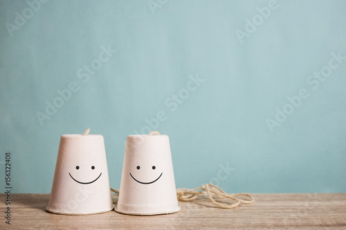 classic paper cup phone on wood background photo