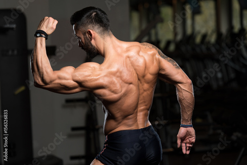 Bodybuilder Posing Biceps After Exercises