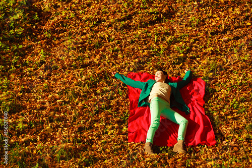 Woman sitting on autumnal leaves