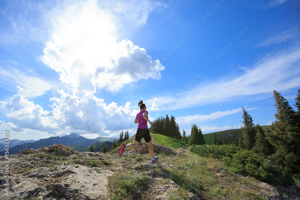 healthy woman running on beautiful mountain peak
