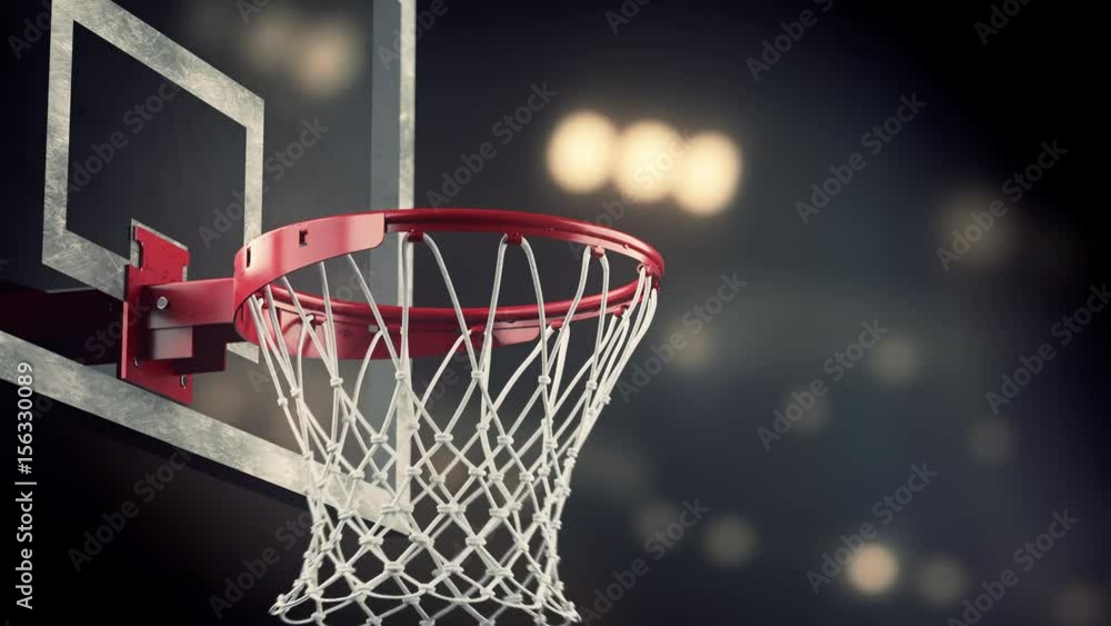 A throw in a basketball ring on the background of yellow spotlights A throw in a basketball ring on the background of yellow spotlights