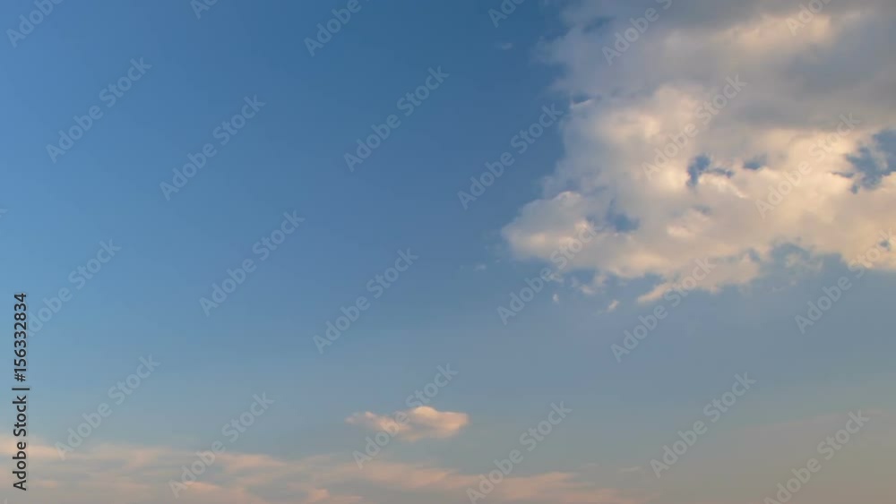 Russia, time lapse. Formation and rapid movement of white clouds of different shapes in the blue sky in late spring at sunset. Russia, time lapse. Formation and rapid movement of white clouds of different shapes in the blue sky in late spring at sunset.