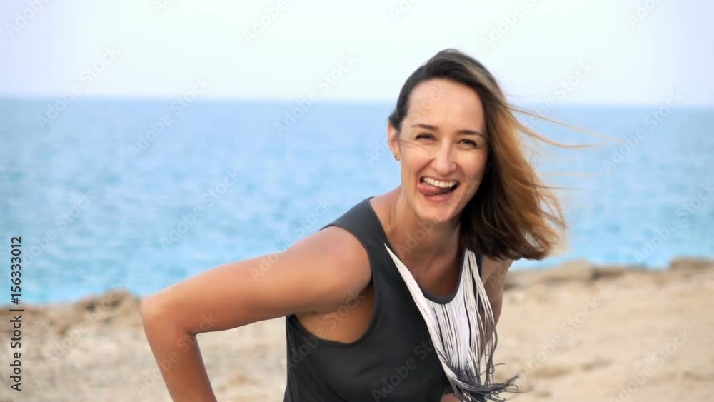 Portrait of happy, pretty woman standing on beach, super slow motion 240fps
Portrait of happy, pretty woman standing on beach, super slow motion 240fps