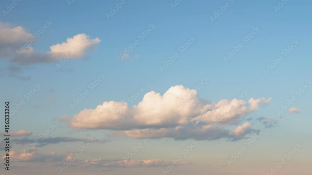 Russia, time lapse. Formation and rapid movement of white clouds of different shapes in the blue sky in late spring at sunset. Russia, time lapse. Formation and rapid movement of white clouds of different shapes in the blue sky in late spring at sunset.