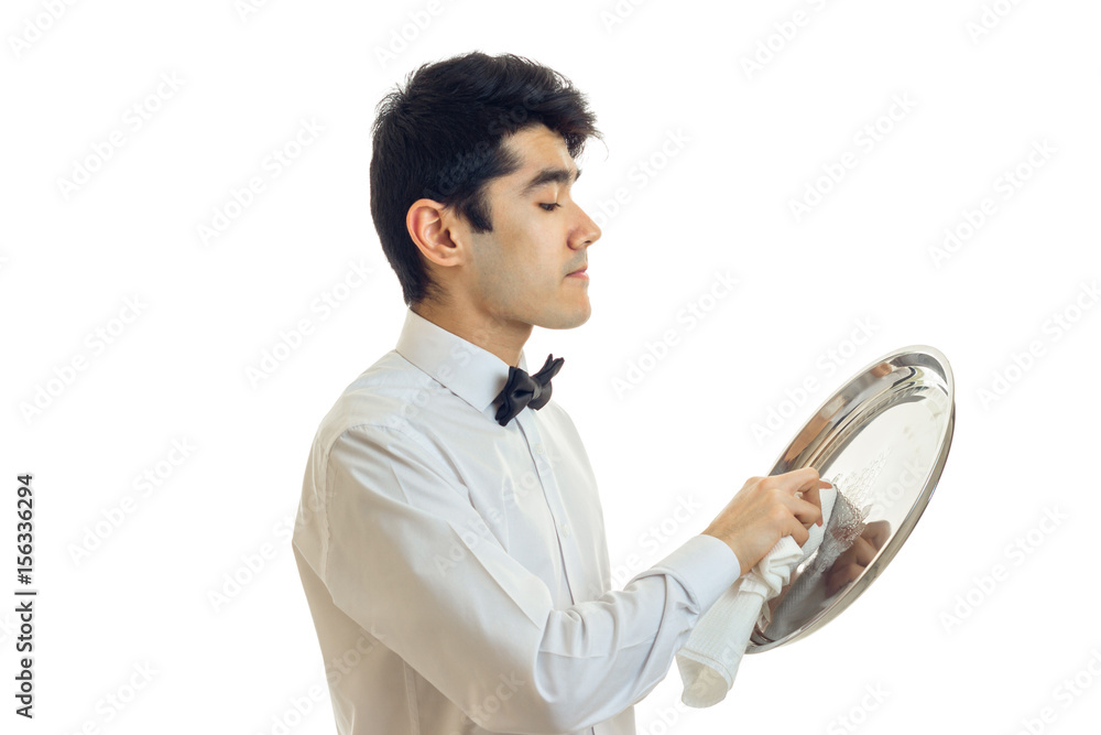 young cute waiter stands sideways and gently rub until luster ware tray young cute waiter stands sideways and gently rub until luster ware tray