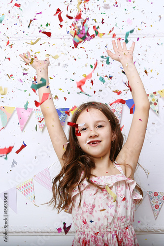 Child and confetti. Positive emotions.