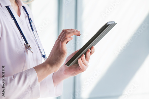 Female doctor working on tablet computer