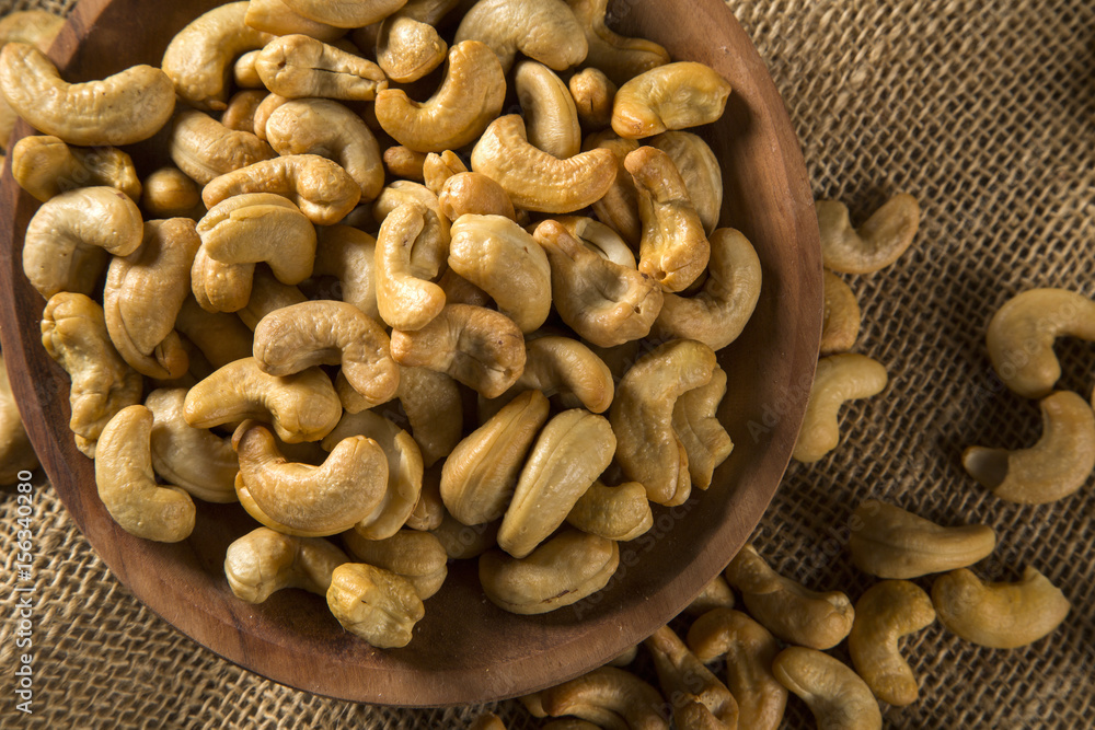 Fototapeta premium Cashew nuts in wood bowl on wood background