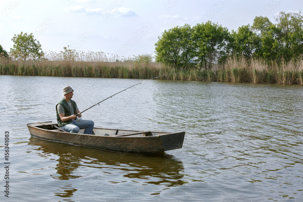 fisherman in small boat on fishing day.