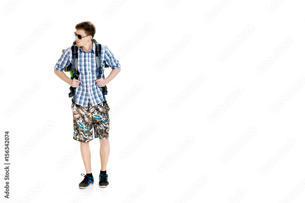 Naklejka premium Young hiker in sunglasses with backpack on white background