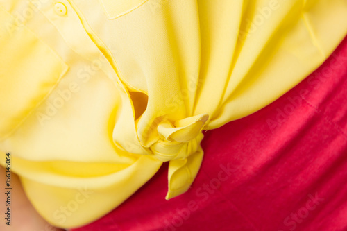 woman in yellow knotted shirt closeup