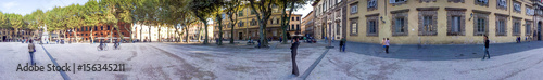 LUCCA, ITALY - OCTOBER 2015: Tourists along Napoleon Square. Lucca attracts 2 million tourists annually