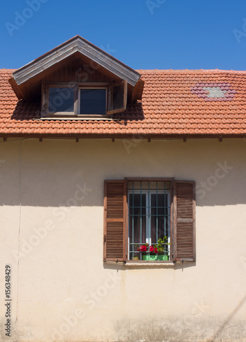 Fragment of vintage facade with window and roof. Tel Aviv, Israel. © Lapidus