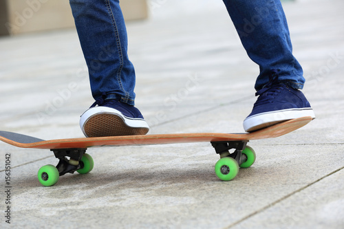 Skateboarder legs skateboarding at city © lzf