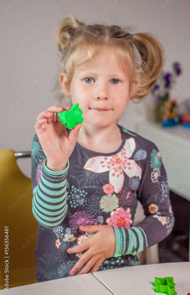 cute little girl playing with plasticine cute little girl playing with plasticine