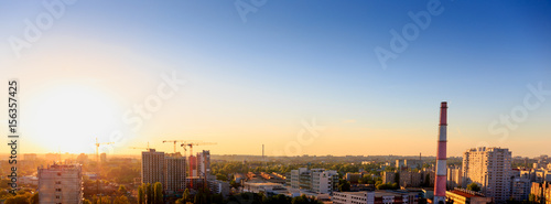 Aerial panoramic view of evening sunset cityscape, industrial area