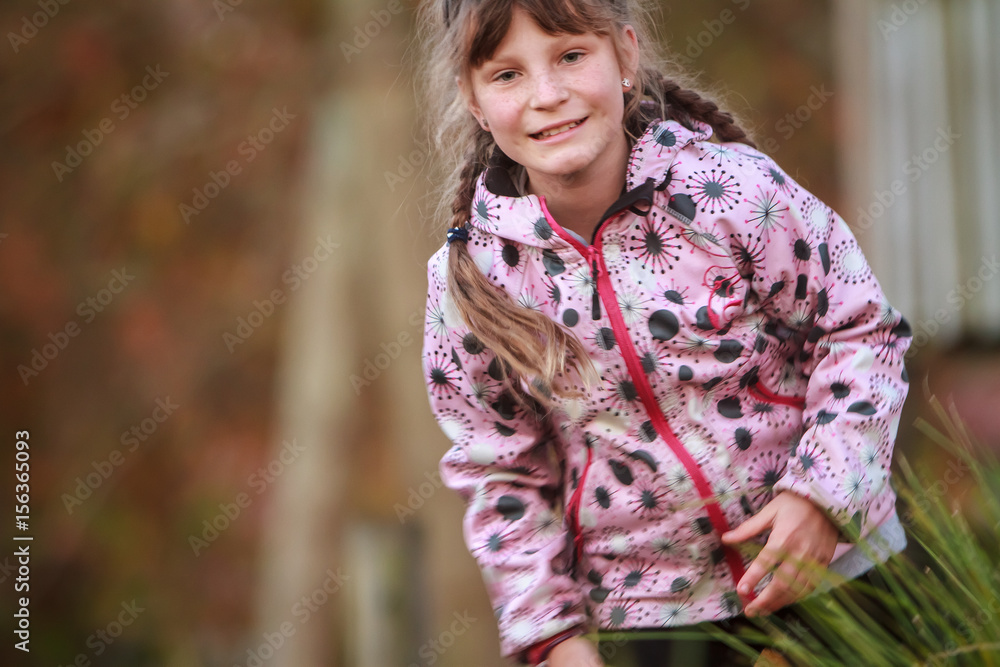 outdoor portrait of young happy child girl playing in park on natural background outdoor portrait of young happy child girl playing in park on natural background