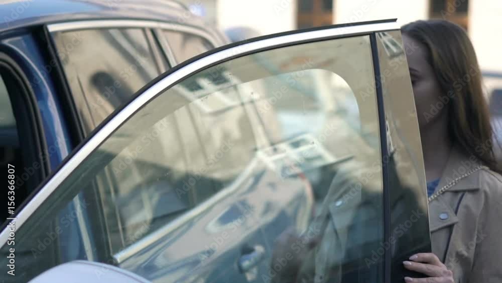 Young attractive woman entering car in city
Young attractive woman entering car in city