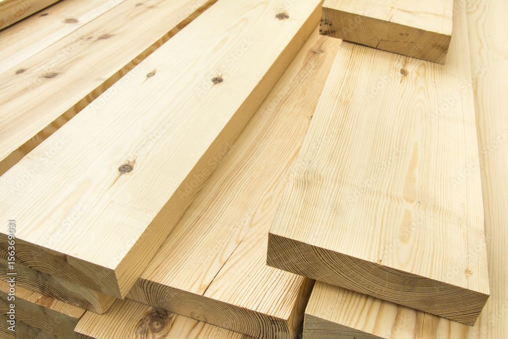 Piled lumber near a lumber mill, waiting for shipping. Wood Mill. Lumber and wood slice.