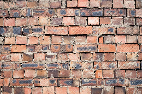 Weathered red brick wall texture seamlessly tileable