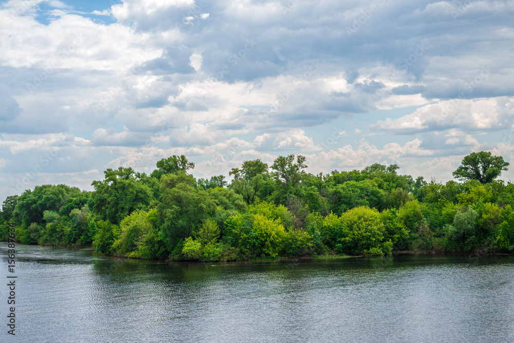 Natural background, lake or river, forest and sky with clouds, on the whole frame. Horizontal frame Natural background, lake or river, forest and sky with clouds, on the whole frame. Horizontal frame