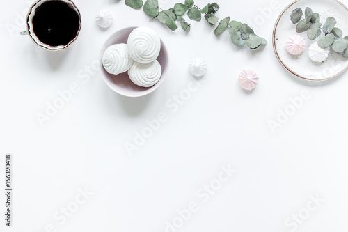 sweet marsh-mallow and flowers on woman white desk background top view mock up