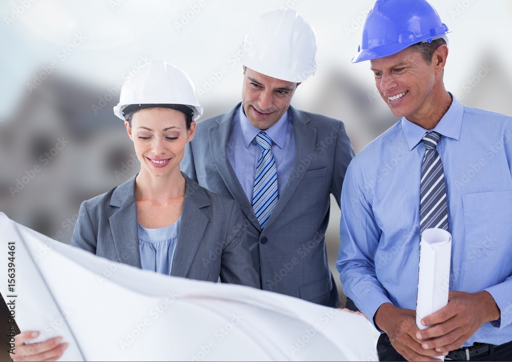 Architects with blueprints on building site Architects with blueprints on building site