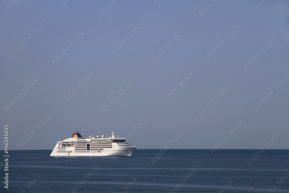 Cruise ship at the sea, sky and horizon.