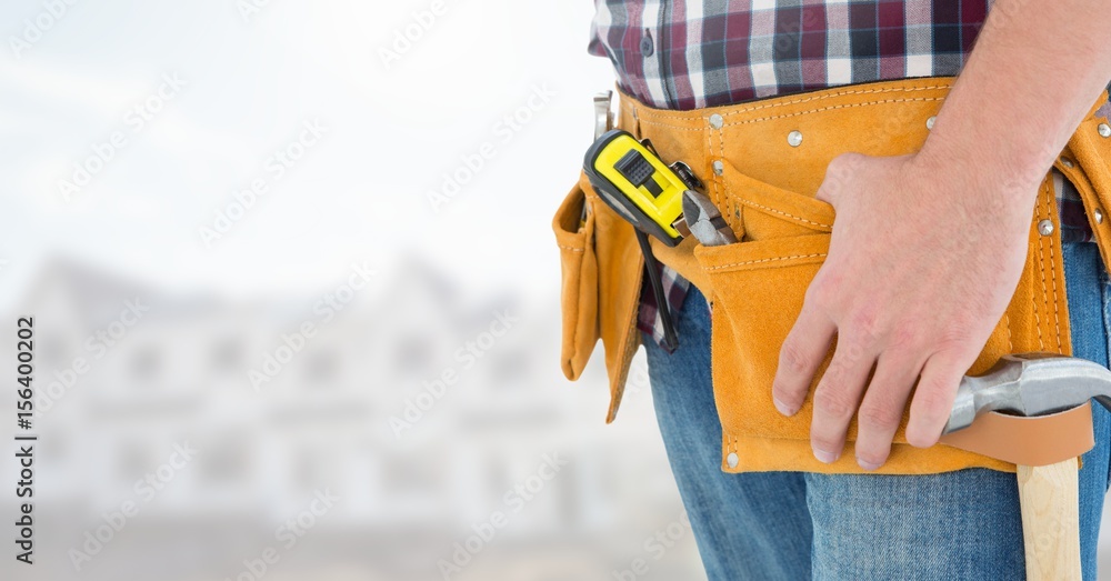 Carpenter with tools on building site Carpenter with tools on building site