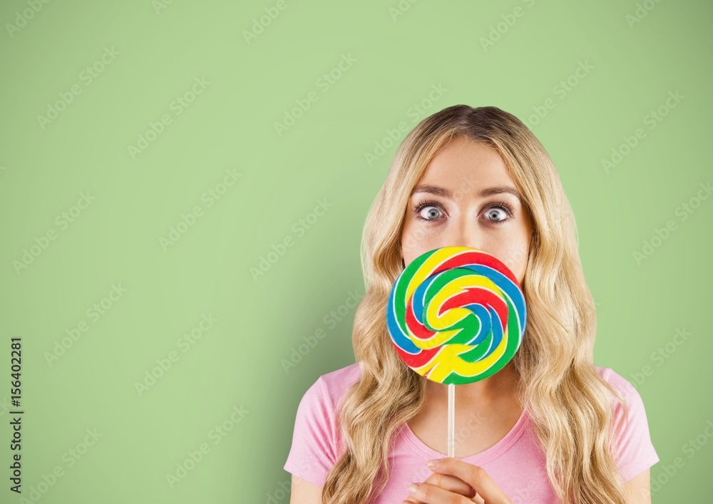 Blond-hair girl hidded by a candy with green background
