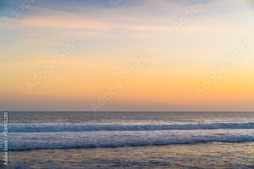 Background Sunset Ocean. Clean Water  Waves  colored Sky  Horizon. Background Tropical Island Seascape. Sea water Surface  Sea water Texture  Nature  Resort  Sea Vacation. Orange Ocean Background