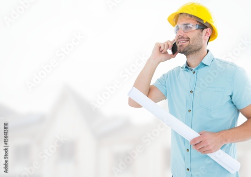 Architect with blueprints on building site photo