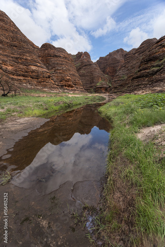 Reflections of the domes in the creek leading to Cathedral Gorge in the Bungle Bungles, Purnululu World Heritage Listed National Park, Western Australia during the Wet Season.