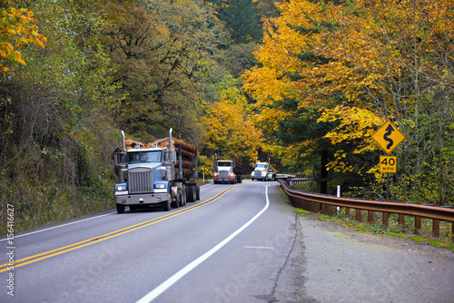 Convoy of trucks on the beautiful autumn highway