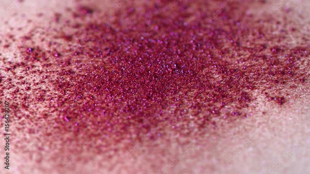 Closeup of pink shimmer on the white background, abstract slow motion Closeup of pink shimmer on the white background, abstract slow motion