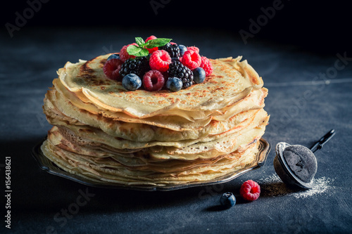 Tasty stack of pancakes with blueberries and raspberries