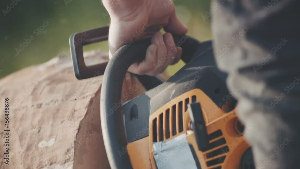 Close up of man using chainsaw. Close up of man using chainsaw.