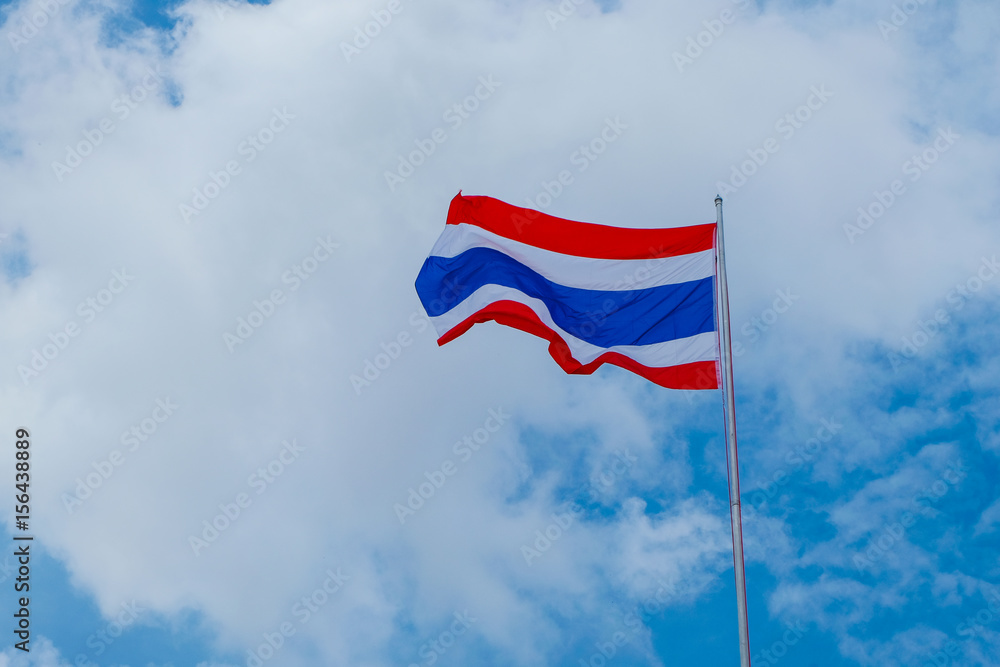 Flag of Thailand. The Thai flag is waving in the blue sky and beautiful robe. Good morning weather.