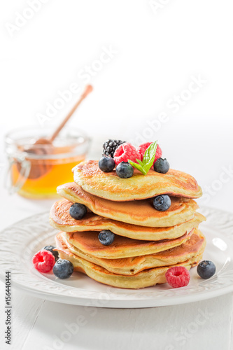Delicious american pancakes with maple syrup and berries