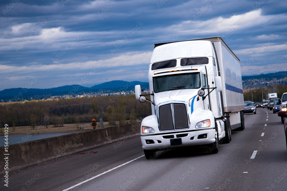 Big Rig American semi truck carring cargo on highway Big Rig American semi truck carring cargo on highway