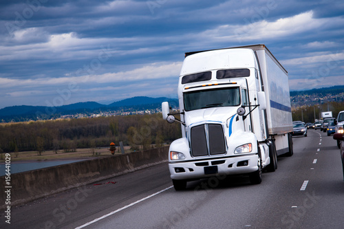 Big Rig American semi truck carring cargo on highway