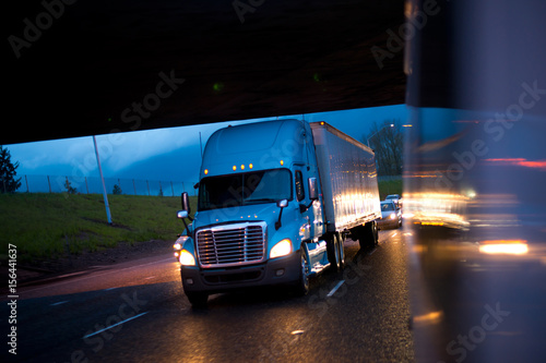 Bright semi truck in raining night lights on highway © vit