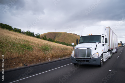 Semi trucks convoy moves interstate highway in California