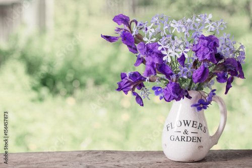 Fototapeta Naklejka Na Ścianę i Meble -  beautiful bouquet with irises on wooden table