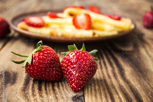 strawberry and crepes on background photo