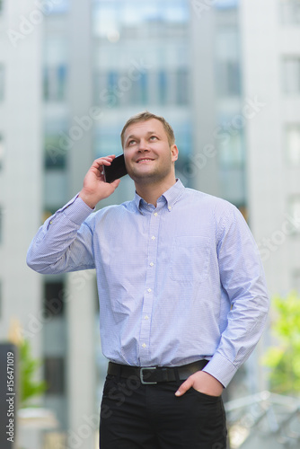 Young businessman talking on his phone outdoors