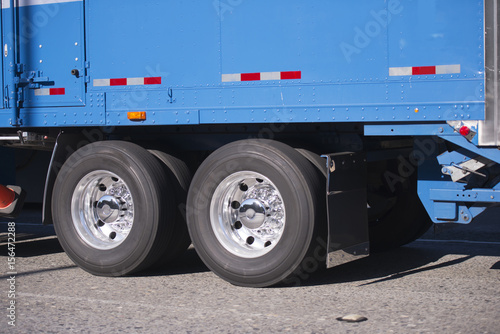 blue semi truck trailer with axles and wheels