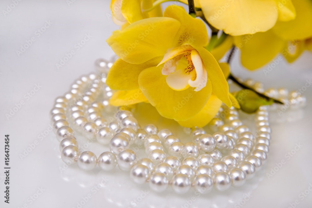 pearl and yellow Orchid on white glass pearl and yellow Orchid on white glass