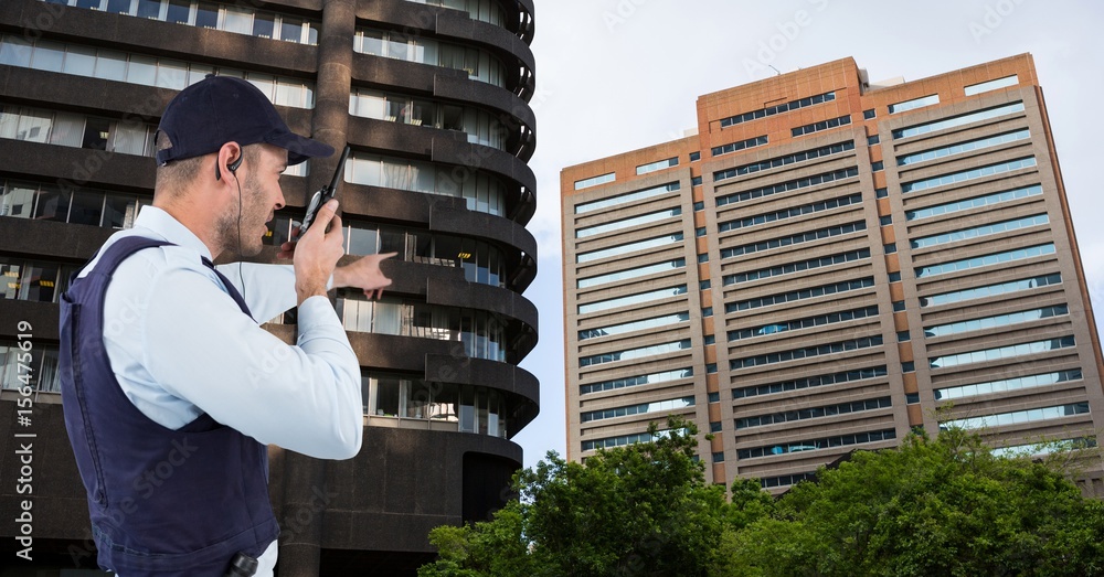 Fotografía Security guard pointing at building walkie talkie